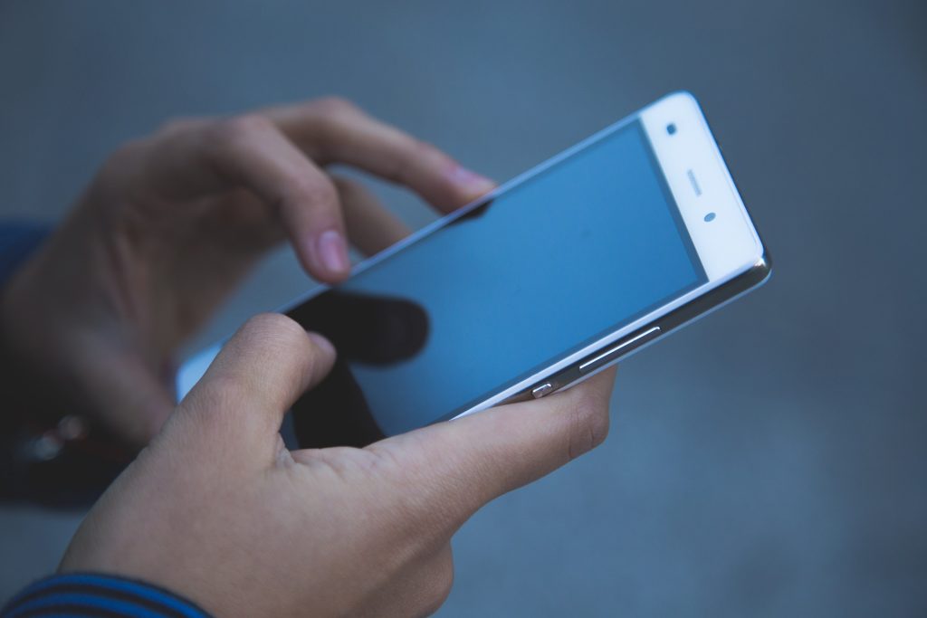 Image of a person holding their phone