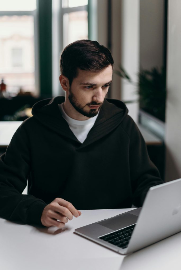 Image of man looking at Laptop